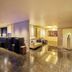 Hotel Mystays Premier Hamamatsucho in Tokyo, sleek suite with lounge seating and glossy marble floors