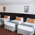 Duomi Hotel Buenos Aires room with four twin beds and wood flooring in Buenos Aires
