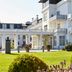 Kurhotel Skodsborg in Copenhagen, white spa hotel with manicured lawn and terrace