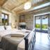 Asion Lithos, Kato Asites stone bedroom with iron bed and balcony view