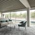 Go Hotel Østerport in Copenhagen lounge with sofa, chairs and floor-to-ceiling windows overlooking greenery
