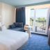 Thalazur Royan - Hôtel & Spa room with king bed, sofa, balcony doors and sea view in Royan