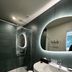Domaine De La Corniche in Rolleboise bathroom with glass shower, oval mirror, and white sink