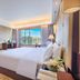 Lihua Grand Hotel Taiyuan guest room with king bed and city view through large window