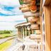 Power Park Accommodation in Kauhava with log-cabin exterior and patio overlooking the road and greenery