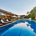 Crystalbrook Byron in Byron Bay with a long outdoor pool, sun loungers, and lush tropical surroundings