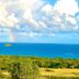 Mount Nevis Hotel in Newcastle with tropical hillside, ocean view and rainbow over the sea