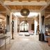 Le Jardin Des Douars in Essaouira lobby with rustic beams, arched window, and lounge seating