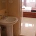 Azzurro Di Boracay Resort bathroom with pedestal sink, toilet, and view into a bedroom in Boracay