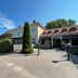 Åsby Hotell in Hallstahammar with a driveway, landscaped entrance, and clear blue sky