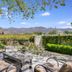 Chateau de Vie Calistoga courtyard patio with seating, mountains and vineyard views