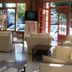 San Remo Palace Hotel, Villa Gesell lobby with lounge seating and large windows facing the street