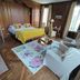 Chateau De Montreuil room in Montreuil with wood paneling, floral rug, bed, desk, and seating area