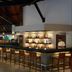 Habarana Village by Cinnamon bar with high stools and illuminated liquor shelves in Habarana