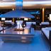 Hotel Zurserhof in Zürs lounge with central fireplace and white seating around a modern canopy hood