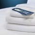Travelodge Dartford towel stack with a thank-you tag on a white bed in Dartford