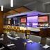 Hilton Woodland Hills/Los Angeles dining area with bar, modern tables, and lit backlit shelves