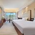 Lihua Grand Hotel, Taiyuan: spacious guest room with two beds and city-view windows