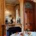 B&B Chateau de Villersexel in Villersexel: ornate salon with fireplace, chandelier, and tall window