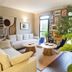 Canal Aigues Mortes lounge with sectional sofas, coffee tables, plants and wall art in Aigues-Mortes