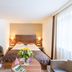 Austria Classic Hotel Hölle Salzburg guest room with twin beds, desk, chairs and large window