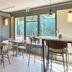 Campanile Nature - Sannois Ermont breakfast area with tables, chairs and large windows in Sannois