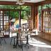 San Remo Palace Hotel in Villa Gesell dining area with tables and garden view through glass doors