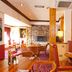 Premier Inn Huddersfield Central lounge with tables, leather chairs, fireplace and wine display