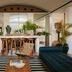 Palm Heights, North Side: stylish lounge with striped rug, bar seating, and tropical plants