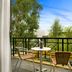 Quest Narre Warren balcony with bistro table, chairs and leafy outdoor view in Narre Warren