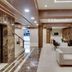 Hotel Centra-Ahmedabad lobby in Ahmedabad with marble floors, seating area, elevators and reception desk