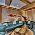 Königshof Hotel Resort in Oberstaufen lounge with teal sofas, round coffee tables and wood-paneled walls