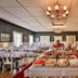 Järvsöbaden in Järvsö dining room with buffet table, set tables, chandeliers and hardwood floors