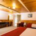 Tall Timbers Tasmania in Smithton guest room with three beds, wood-paneled ceiling, and desk