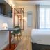 ibis Styles Paris Eiffel Cambronne room with bed, desk, chair and window in Paris