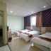 Shanghai Huijia Business Hotel in Shanghai room with three single beds, TV and window curtains