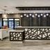 Homewood Suites by Hilton Burlington lobby front desk with modern geometric paneling and pendant lights