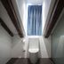Petit Palace Plaza del Carmen Madrid compact modern bathroom with toilet, glass shower and blue curtain