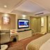 Zhong'an Huana Holiday Hotel in Hangzhou guest room with TV, desk, chair and visible bathroom