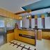 Hotel G Shy, Bhopal reception desk and lobby interior with wood paneling and glass partition