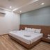 Hotel G Shy, Bhopal: simple guest room with double bed, wall-mounted TV, and air conditioning