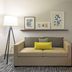 Country Inn & Suites by Radisson, Doswell, VA guest room with sofa, floor lamp and framed wall art