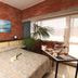 Hotel Marina in Marina di Massa room with double bed, brick wall, large window and breakfast tray