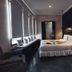 Ambre Epices Medina Riad in Marrakech guest room with king bed, dark walls, and window seat