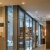 Charm Hotel Budapest in Budapest corridor with glass-walled lounge and seating area