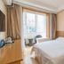 Ruizhao Hotel (Beijing Guomao Branch) in Beijing room with bed, desk and window seating area