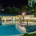 Royal Plaza Hotel in Tiberias, outdoor illuminated pool at night with lounge chairs and curved railing
