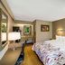 Red Roof Inn Asheville - Biltmore West guest room with king bed, desk, lamp and wood flooring