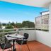 The Wellington Apartment Hotel Brisbane balcony with table, chairs and city skyline view