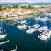 Hope Harbour Hotel in Hope Island overlooking a marina with sailboats, yachts and waterfront buildings